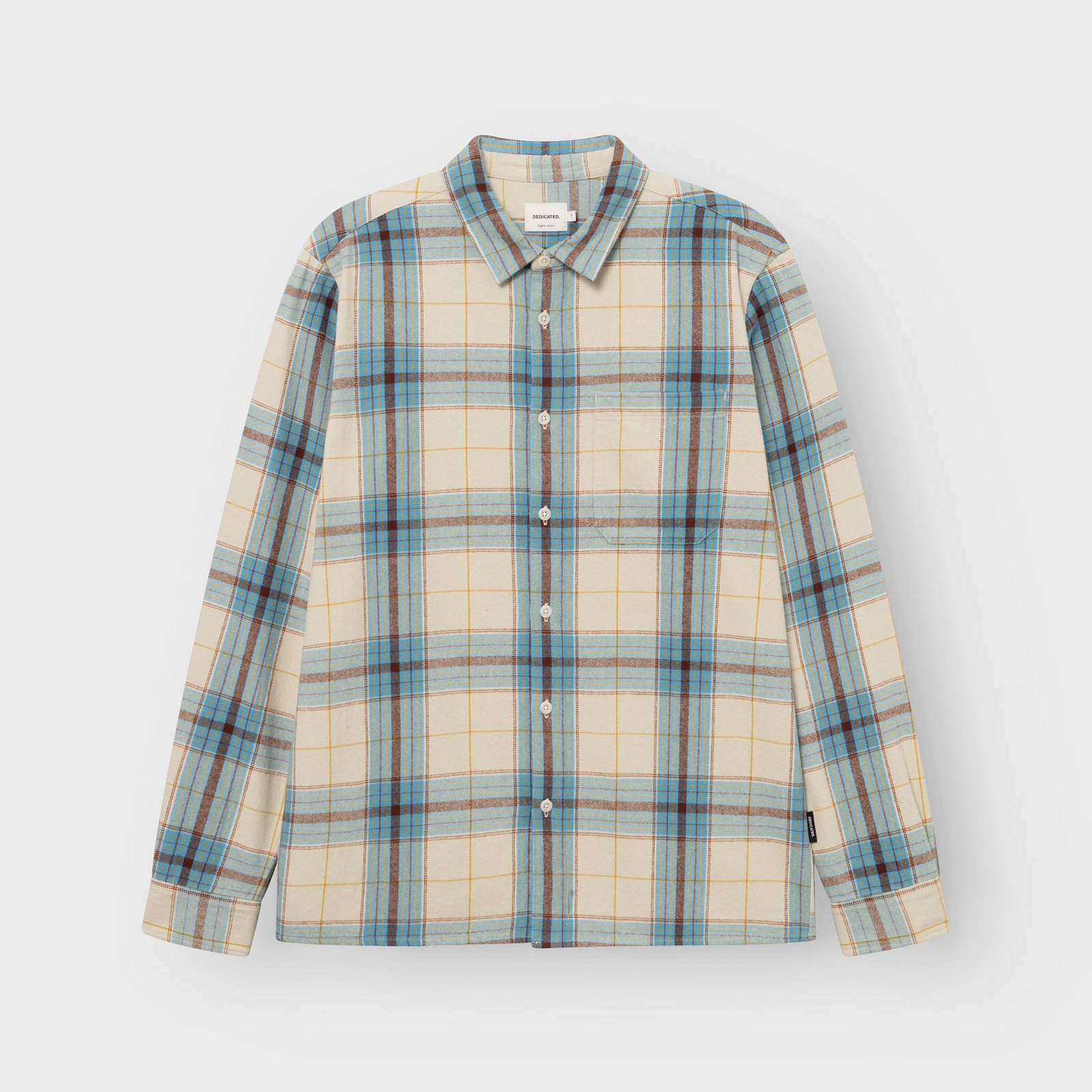 Photo de studio de la chemise Rute en flanelle à carreaux tartan blanc avoine, bleu et brun, à plat sur fond gris clair.