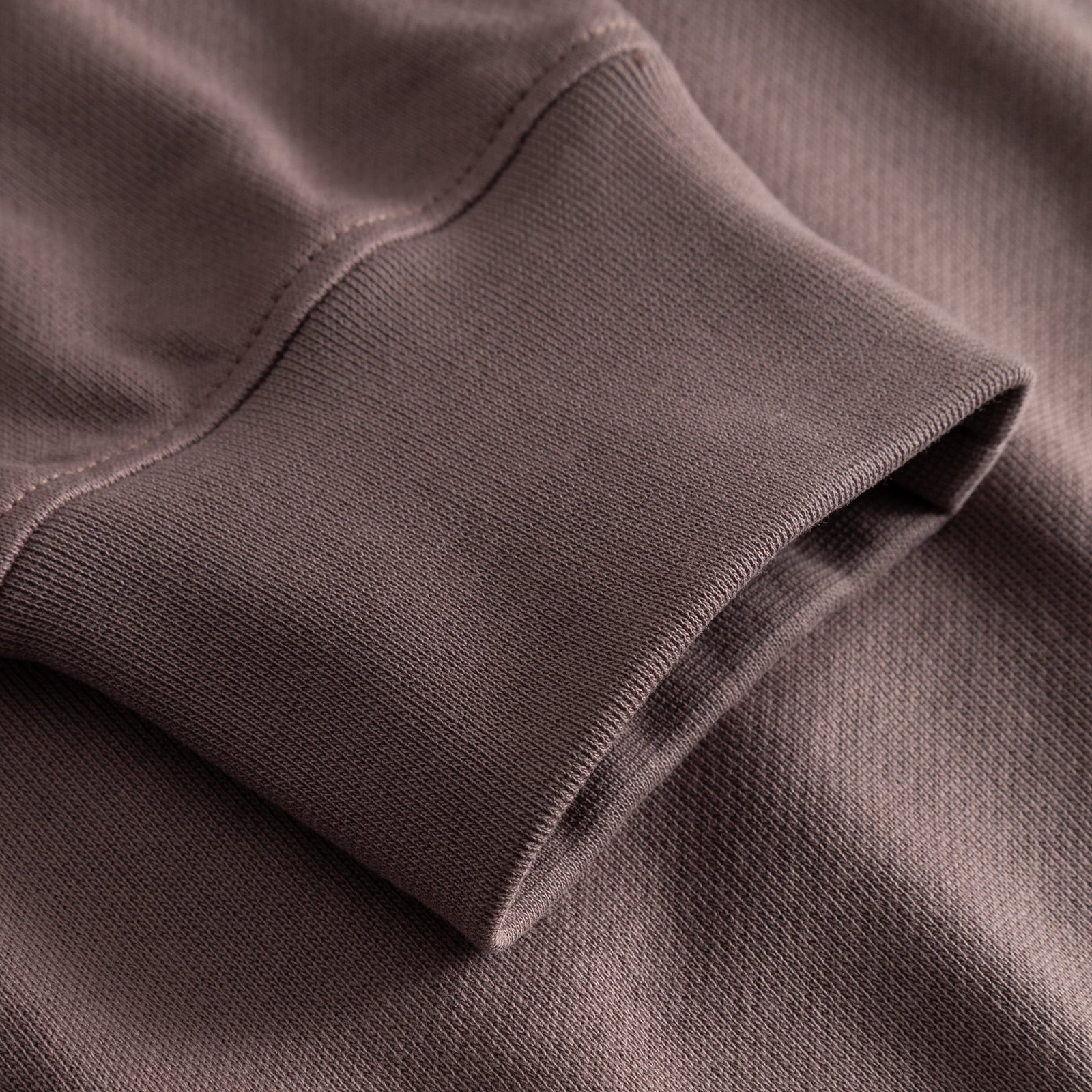 A detailed close-up of the ribbed cuff of the Half Zip Sweatshirt Sandvalla in warm Sparrow Brown.