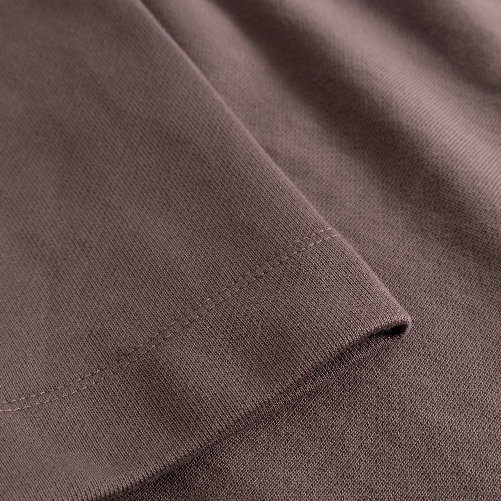 A close-up shot of the rich Sparrow Brown fabric and neat cuff detail on the Gia sweatshirt.