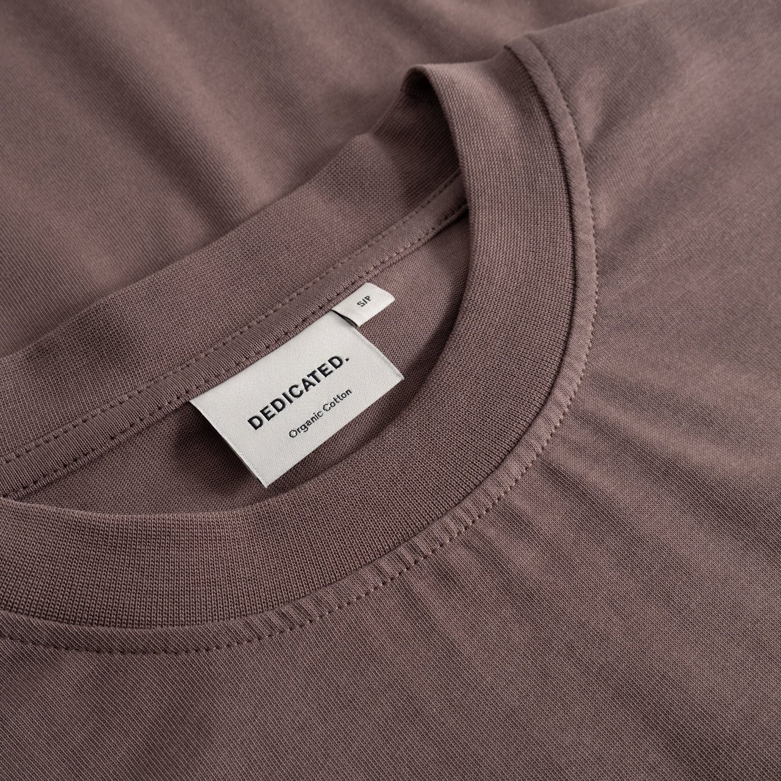 Close-up of the Dedicated Vreta T-shirt in Sparrow Brown, showing the finely ribbed collar and soft organic cotton fabric.