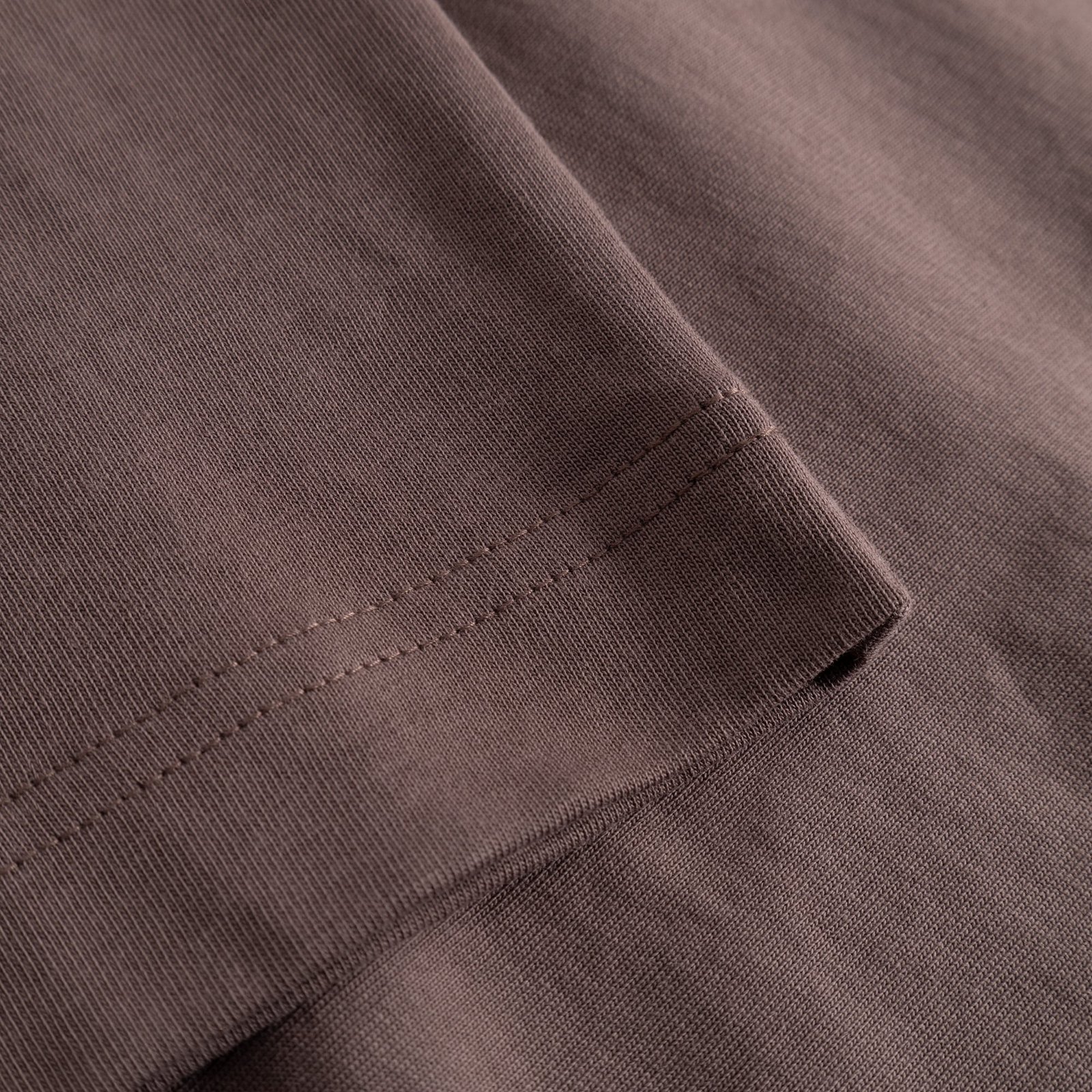 Close-up of the Vreta long-sleeve T-shirt in Sparrow Brown, showing the finely stitched sleeve cuff and soft fabric.