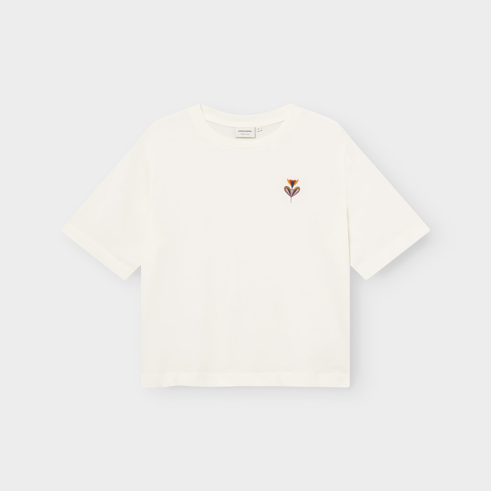 Flat lay of the off-white Vadstena t-shirt, featuring a small embroidered 'Autumn Harvest' flower on the chest.