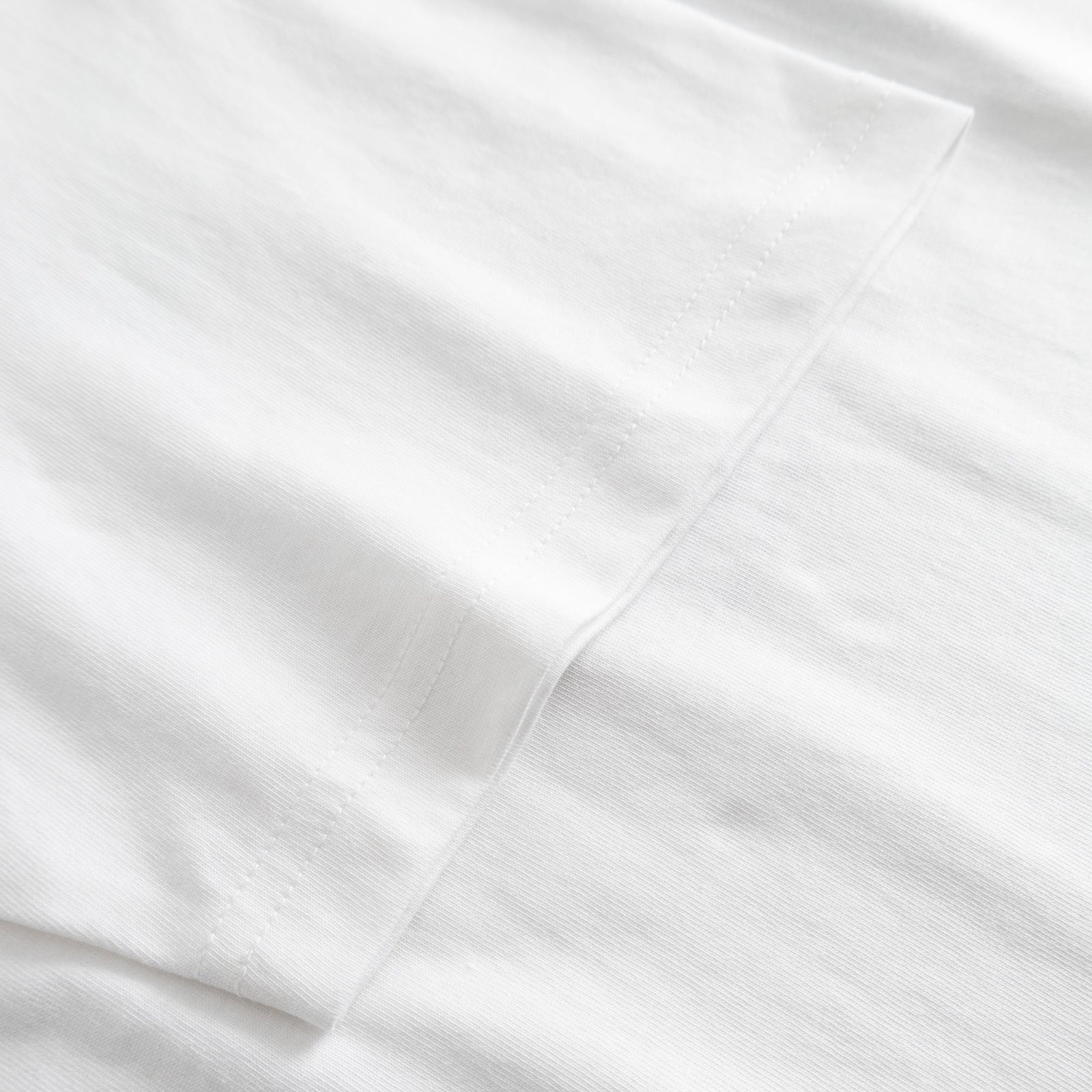 A close-up view showcasing the quality stitching and soft organic cotton fabric of the white Stockholm t-shirt.