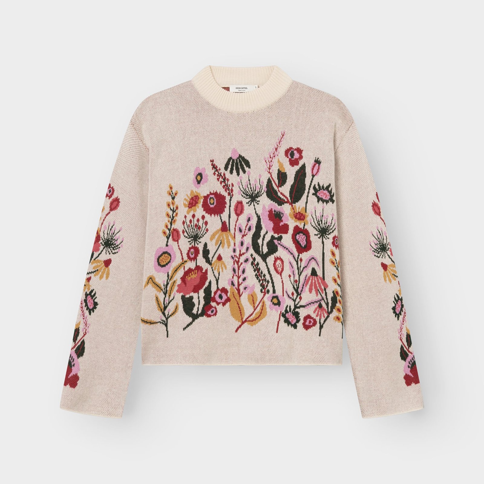 A flat lay of the vanilla white Limhamn sweater, featuring a beautiful jacquard knit pattern of colorful folk flowers.